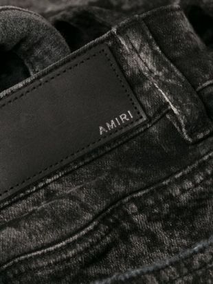 Amiri - Distressed python skinny jeans