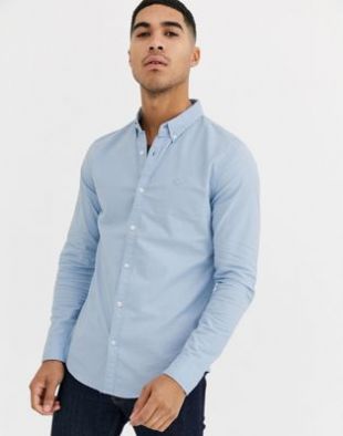 Hollister - Chemise Oxford moulante boutonnée avec logo emblématique - Bleu clair | ASOS