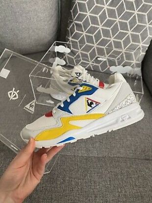 The pair of sneakers Le Coq Sportif x Visionary presented by