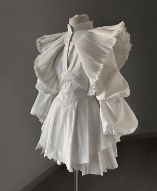 White winged dress worn by Grimes in her Player Of Games Official Music  Video