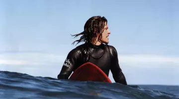 The surfboard-red J. B. (Sam Worthington) in Drift