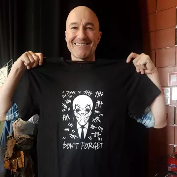 La camiseta negra de Doctor Who que Ross Mullan sostiene en sus manos en su cuenta de Instagram