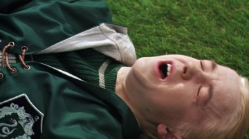 The pull of Quidditch house Slytherin worn by Draco Malfoy (Tom Felton) in Harry Potter and the chamber of the sorcerers