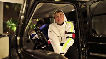 In "Windows Down" Oliver wears a windbreaker Tommy John inspirations Nineties