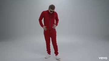 Le bas de survêtement Le Coq Sportif rouge porté par Vald dans son clip Désaccordé