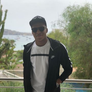 The nike jacket black with stripes on the sleeve view on the profile instagram of Kylian Mbappé