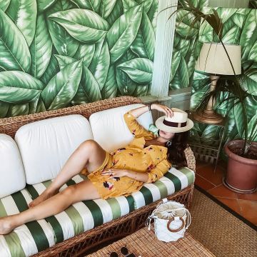 The yellow dress from the brand Sézane scope by Safia Vendome on his account Instagram