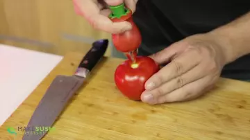 The équeuteur of tomato in the video "8 Innovative Kitchen Gadgets" by Davy Devaux on his channel How To Make Sushi
