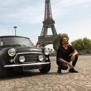 The sneakers black and red Yeezy Boost 350 V2 worn by Bob Sinclar on his account Instagram