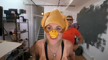 The beak/nose of yellow duck worn by Emy in the video "You guess the price or you the door" of Peter Croce