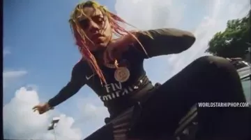 Dark blue and pink PSG jacket worn by 6ix9ine in the music video "Aulos Reloaded" ft. Vladimir Cauchemar