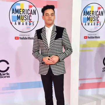 Checked black and white Givenchy tuxedo jacket worn by Rami Malek for the American Music Awards 2018