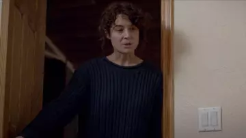 The navy blue jumper by Naomi Wallace (Piercey Dalton) in The Open House