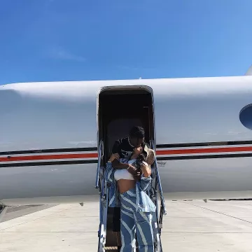 Ganni Mid-Rise Wide-Leg Washed Jeans worn by Kylie Jenner at Coachella Festival 2019