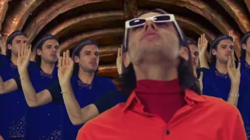 Le col roulé rouge porté par OrelSan dans son clip Dis moi