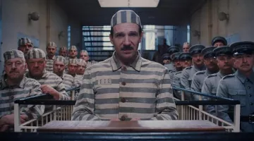 The holding of a prisoner of M. Gustave (Ralph Fiennes) in The Grand Budapest Hotel