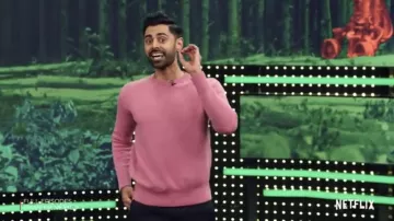 Pink sweater worn by Hasan Minhaj as seen in Pa­triot Act with Hasan Min­haj S02E01