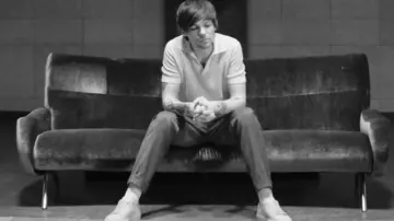 Los pantalones de lino gris con el tobillo enrollado que lució Louis Tomlinson en su videoclip Two of Us