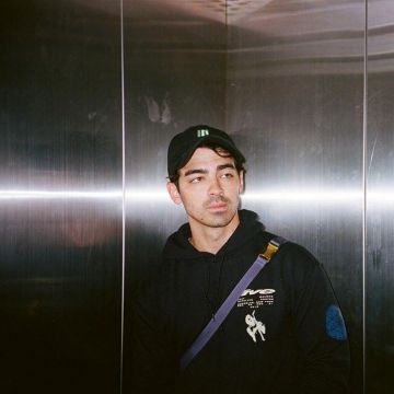 Black cap with green logo worn by Joe Jonas on his Instagram account @joejonas May 21, 2019
