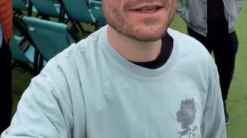 The sweat faded blue with a flower and back print of Dan Smith in the movie clip Joy of Bastille