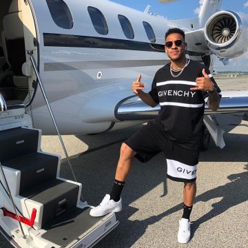 The black t-shirt with white stripes Givenchy worn by Corentin Tolisso on his account Instagram @corentintolisso