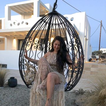 The long dress with golden ornament geometric suede rhinestones worn by the blogger Megan Villiot on the account instagram @meganvlt to Mykonos