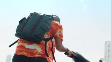 The soft backpack black Gucci Supreme GG carried by Naps in her video clip, It Is Made For That