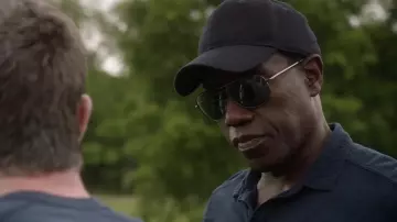 The baseball cap solid black worn by Isaac (Wesley Snipes) in Armed Response