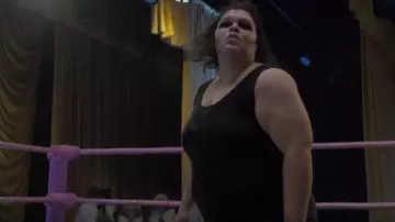 Black playsuit worn by Carmen Wade (Britney Young) as seen in GLOW (Season 03)