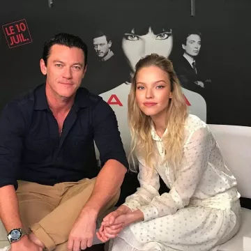 Victoria Beckham oversize satin pajama shirt worn by Sasha Luss in Paris June 24 2019 for the promotion of the film ANNA by Luc Besson