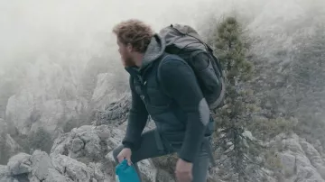 Navy blue sleeveless padded jacket worn by Aaron (Alexander Fehling) in Three Peaks