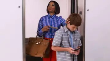 Leather handbag with padlock worn by Jordan Sanders (Regina Hall) in Little