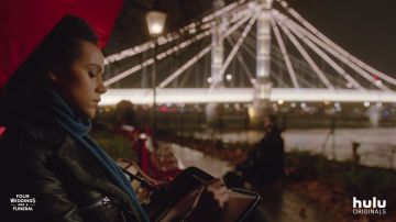 Black leather jacket with faux fur collar worn by Maya (Nathalie Emmanuel) in Four Weddings and a Funeral (Season 1)