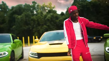 Palm Angels reverse stitch side stripe track pants worn by Quando Rondo in his Dope Boy Dreams music video