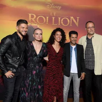 The long dress red patterned striped black worn by Sabrina Ouazani at the premiere of the Lion King at the Grand Rex in Paris on 11 July 2019