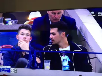 Sandro Bomber jacket in navy worn by  Joe Jonas Us Open September 6, 2019