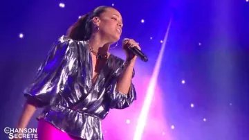 La blouse à effet métallisé avec col v à design cache-cœur Isabel Marant portée par Amel Bent dans La Chanson secrète le 14.09.2019