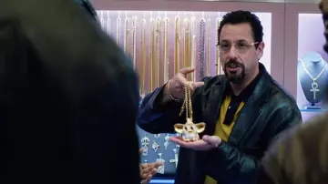 Gold Gizmo pendant necklace of Howard Ratner (Adam Sandler) in Uncut Gems