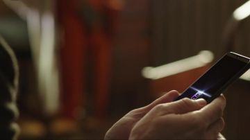 Samsung cell phone used by Phil (Adam DeVine) in Jexi