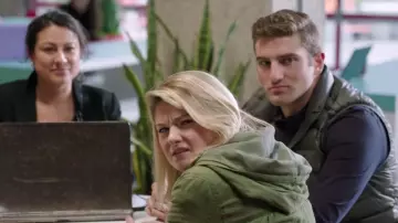 Green padded vest coat worn by a man as seen in Jexi