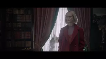 Red coat worn by Kate (Mackenzie Davis) in The Turning