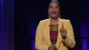 Alice + olivia de­laina snake skin crop top worn by Lilly Singh on A Little Late with Lilly Singh October 1, 2019