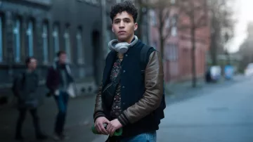 The bomber blue and short brown leather worn by Rahim (Issa Mohamed) in Us, The Wave (S01)