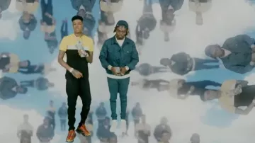 Balenciaga Or­ange & Black Track 2 Sneak­ers worn by Blueface in the YouTube video Blueface - First Class ft. Gunna