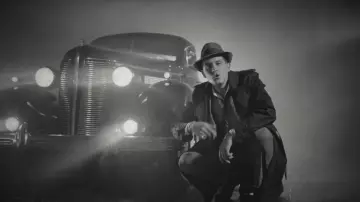 The trench coat-black G-Eazy in his clip Hittin Licks