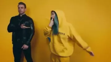 RESERVED Gold Logo Yellow Pullover worn by Billie Eilish in bad guy