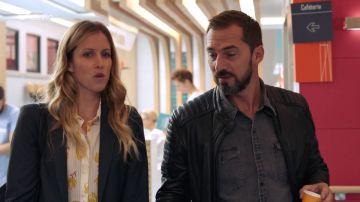 The shirt is white with a brown leaf litter by Virginia (Audrey Looten) in Tomorrow belongs to us