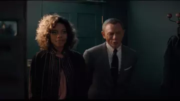 Purple velvet jacket of Eve Moneypenny (Naomie Harris) in No Time To Die