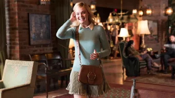 Ralph Lauren Tan crossbody bag worn by Ashleigh Enright (Elle Fanning) in A Rainy Day in New York movie