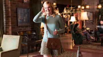 Ralph Lauren Tan crossbody bag worn by Ashleigh Enright (Elle Fanning) in A Rainy Day in New York movie